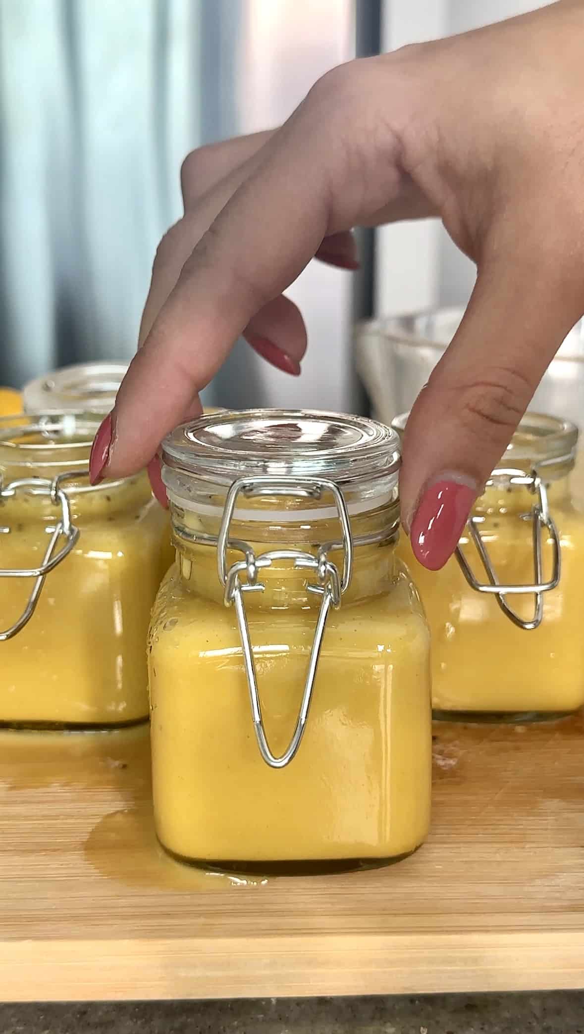 Close-up of lemon and ginger shots in jars, ready for the immune system boost.