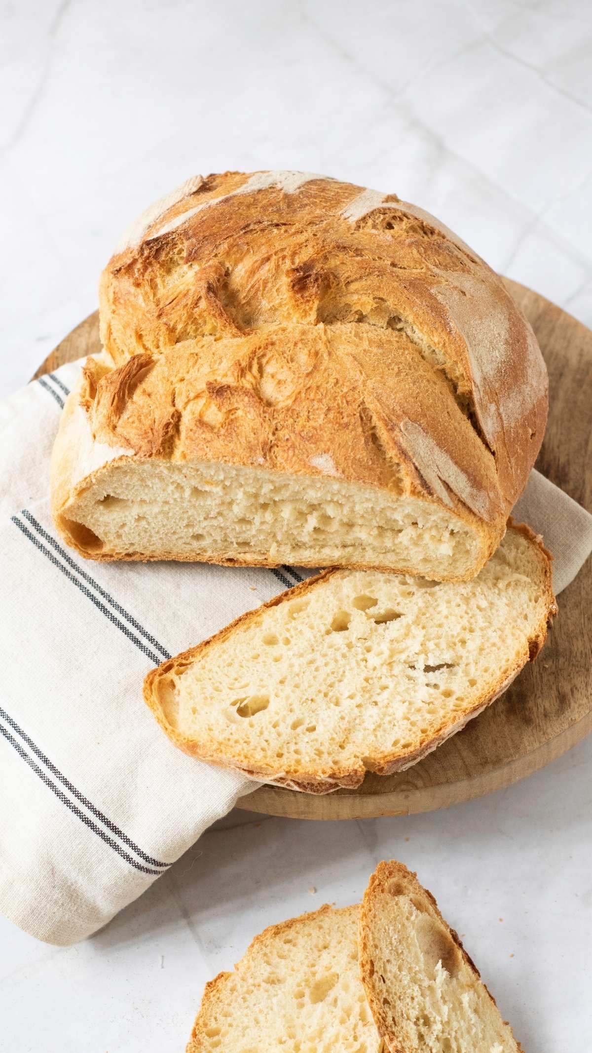 Sliced loaf of artisan bread on a wooden board, showcasing the easy artisan bread recipe.