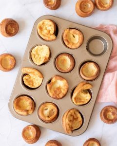 Golden-brown blender popovers in a muffin tin, ready to eat. Perfect easy blender popovers recipe.