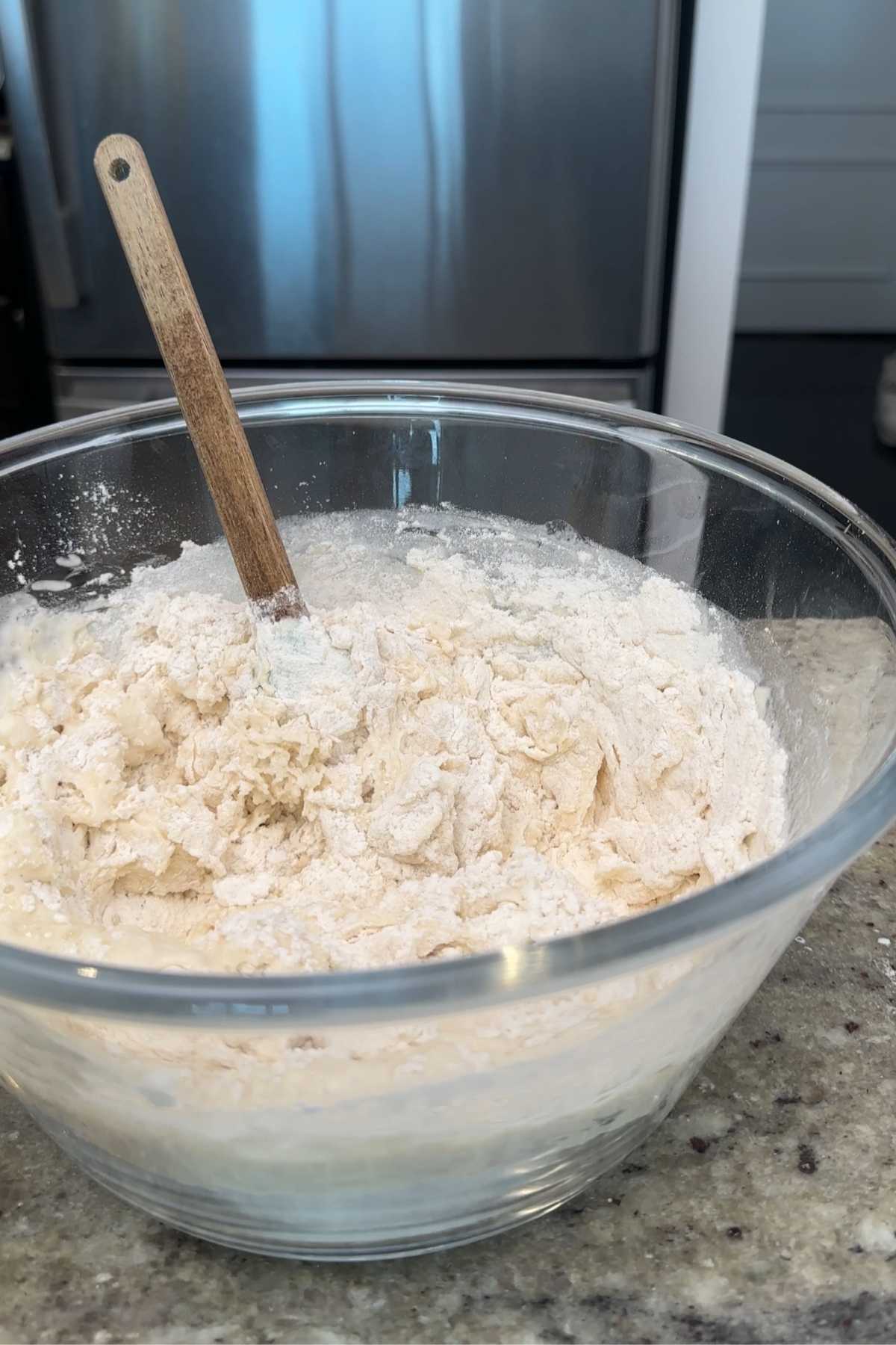 Dough being mixed in a bowl.