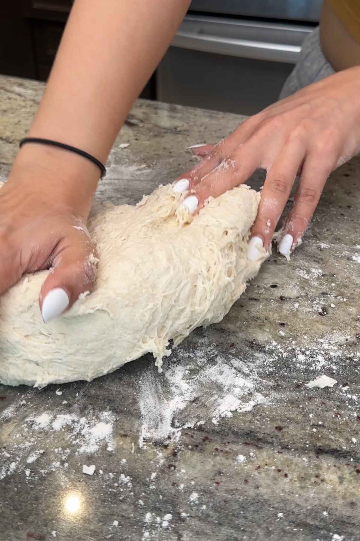 Kneading dough for quick homemade bread bowls.