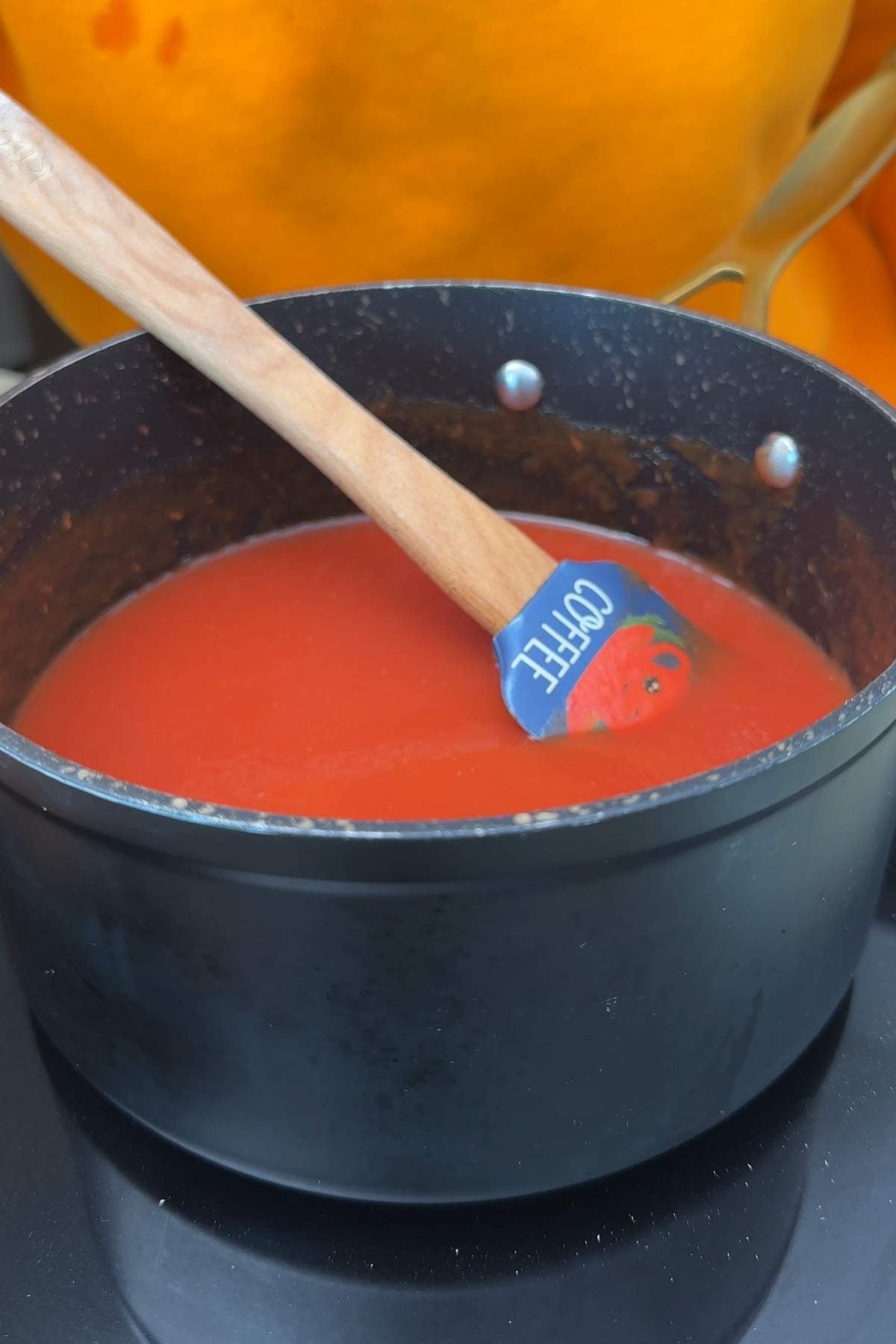 Homemade healthy ketchup simmering in a pot.