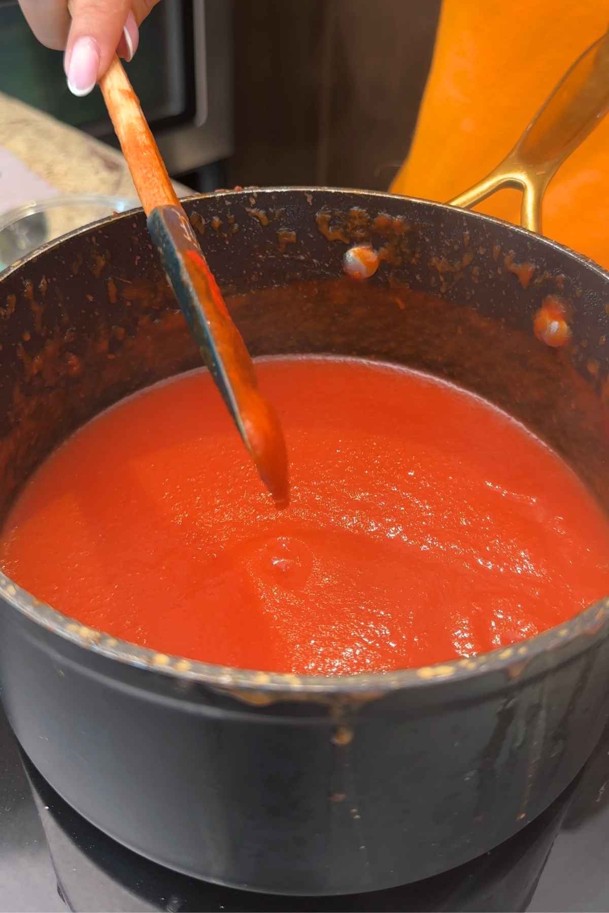 Cooking homemade healthy ketchup.