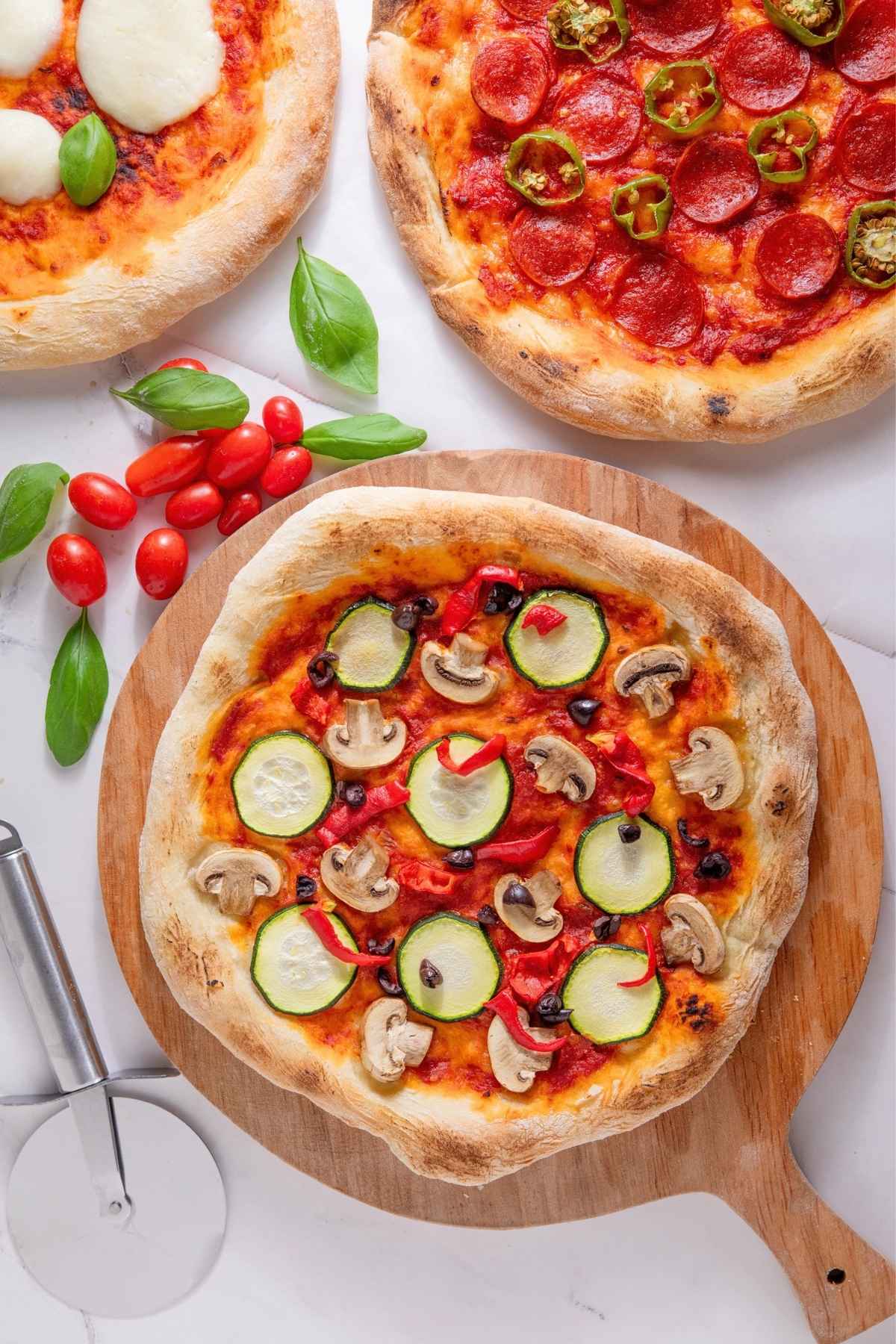 Freshly baked Neapolitan pizzas with toppings.