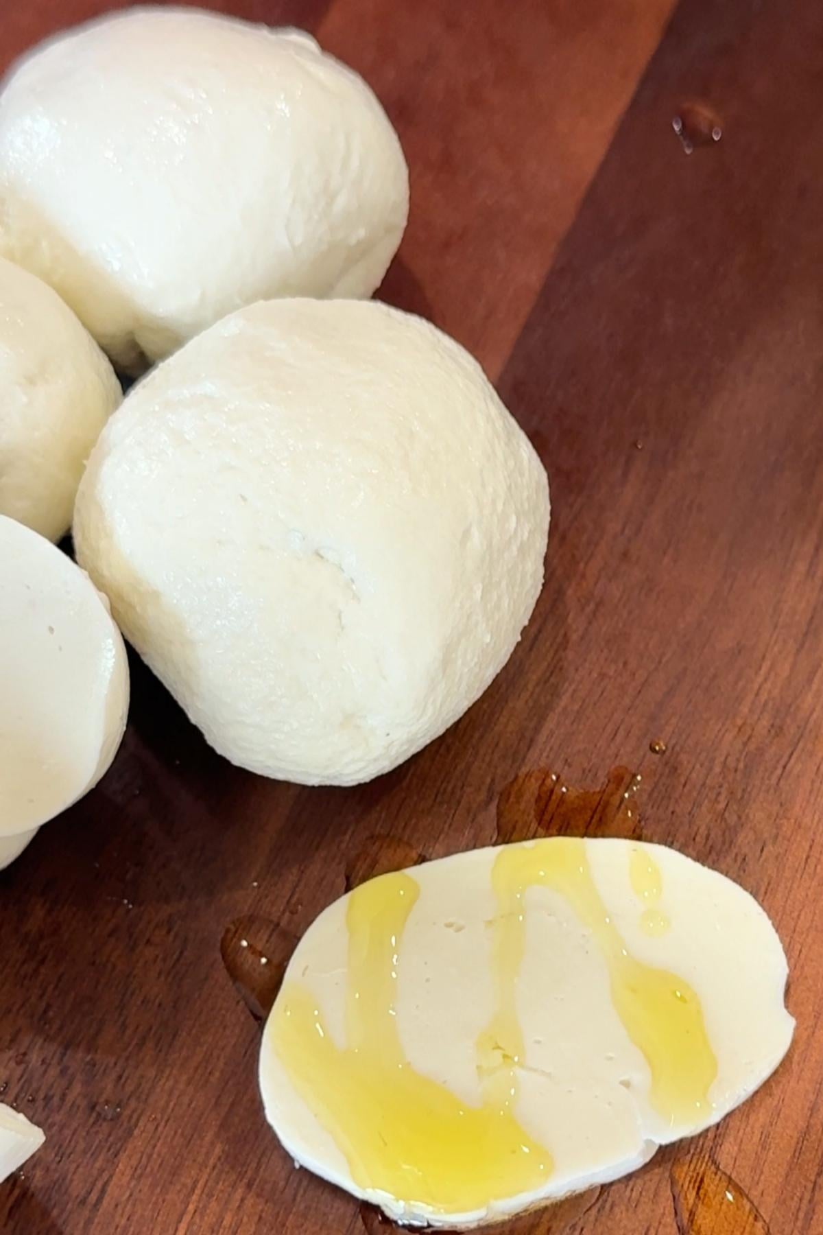 Mozzarella balls with olive oil drizzle.
