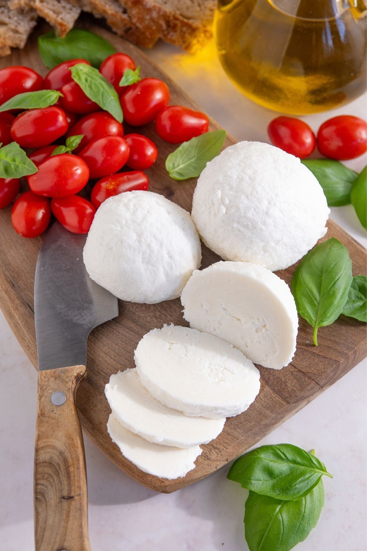 Fresh mozzarella balls with basil and tomatoes.