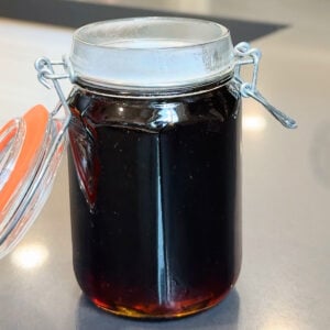Jar of dark syrup for homemade Coca Cola.