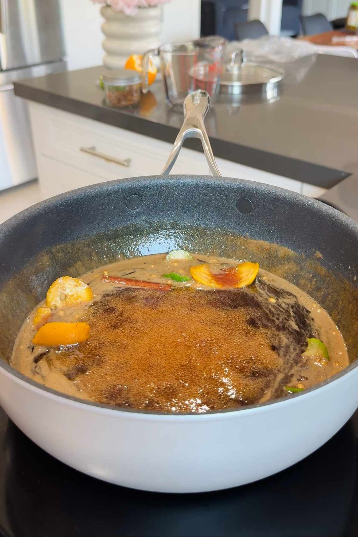 Homemade Coca-Cola recipe simmering in pan.