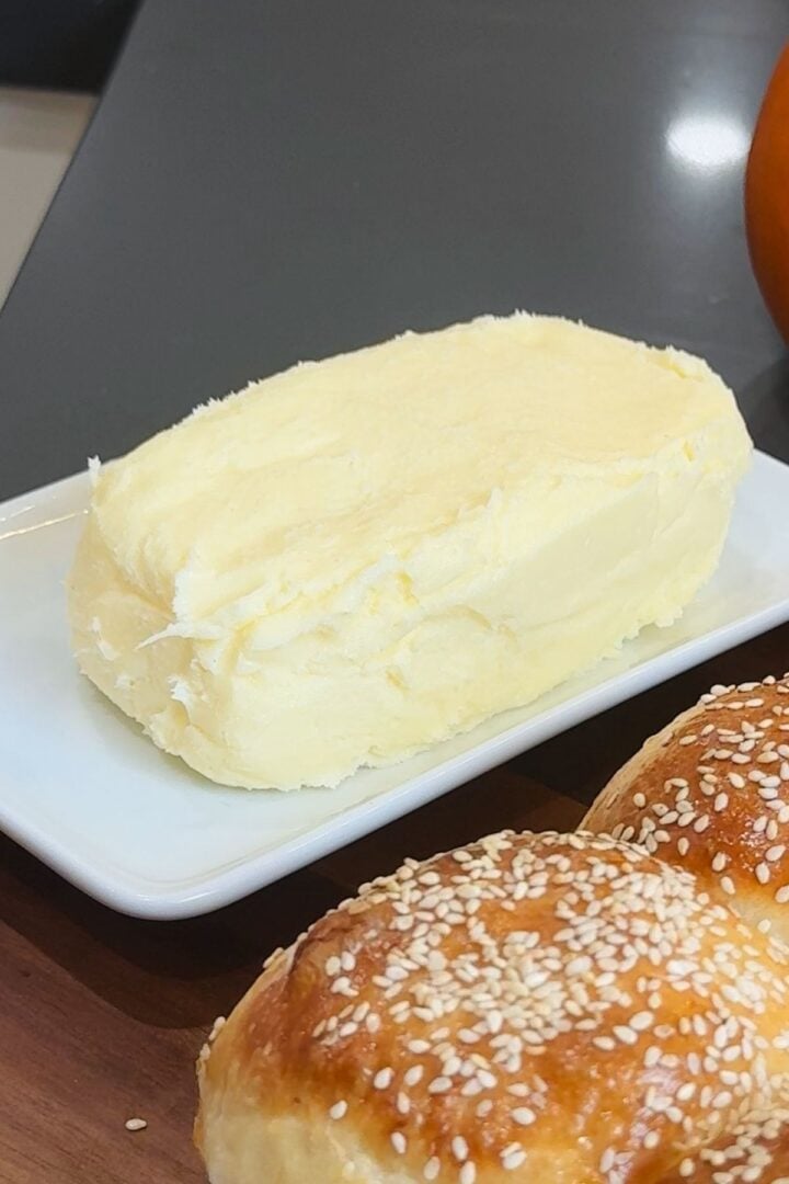 Homemade butter on a white plate.