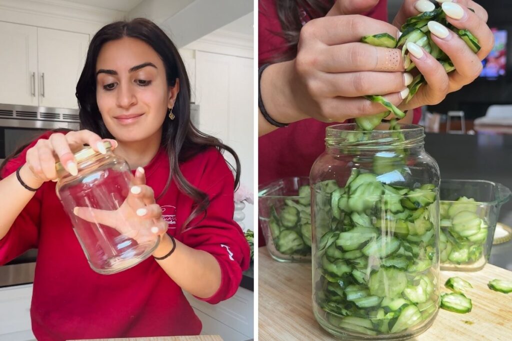 Woman making easy homemade pickles, filling a jar with cucumber slices.