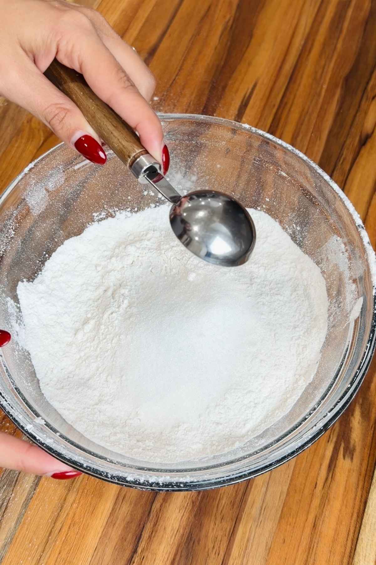 Adding sugar to flour for wonder bread recipe.