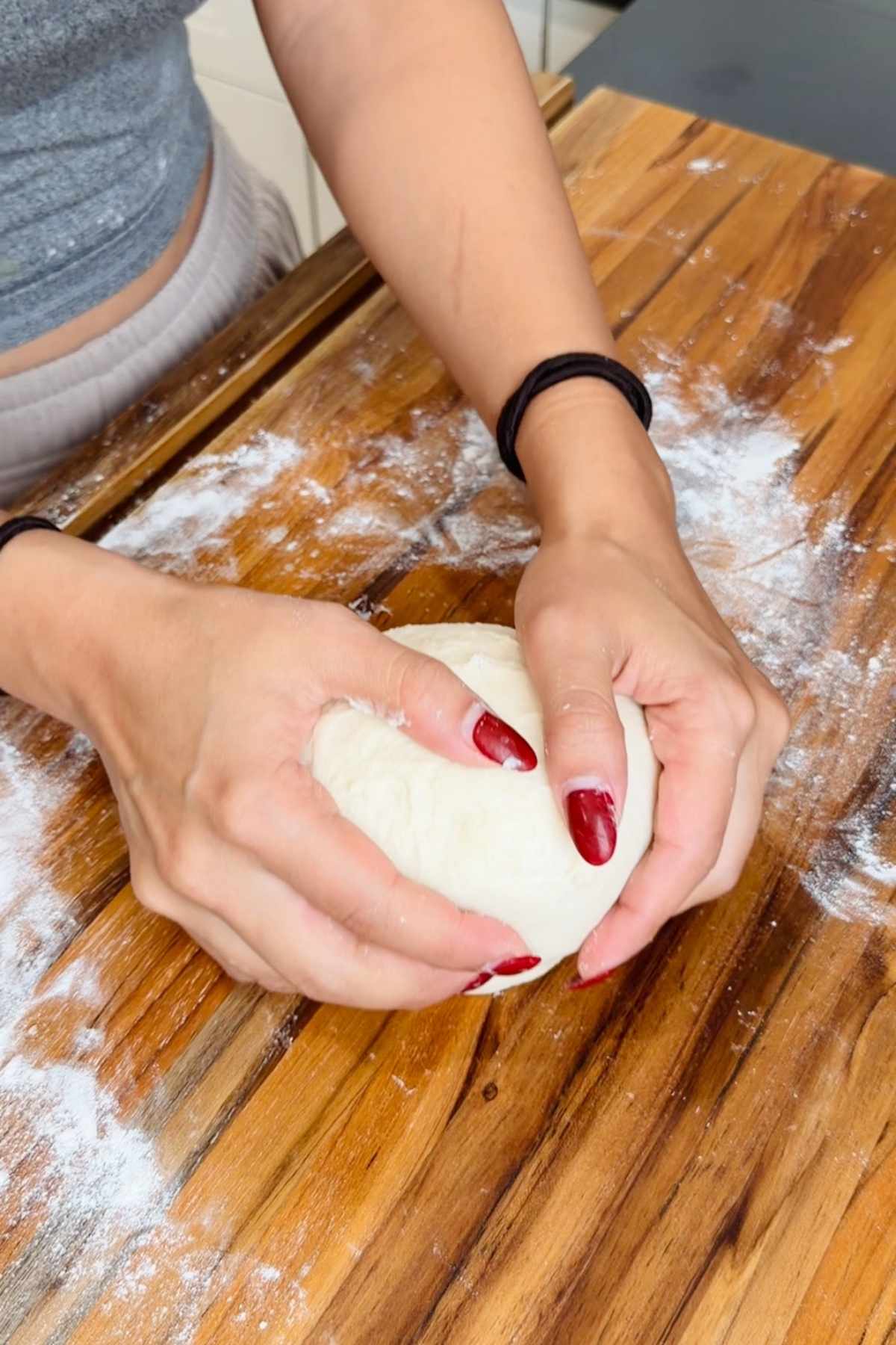 Hands kneading dough for wonder bread recipe.