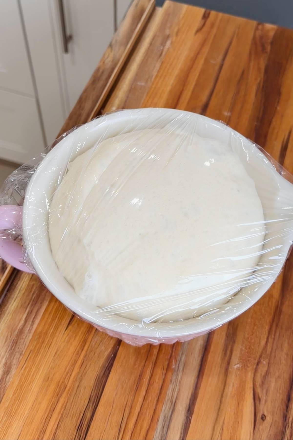 Wonder bread dough rising in bowl.