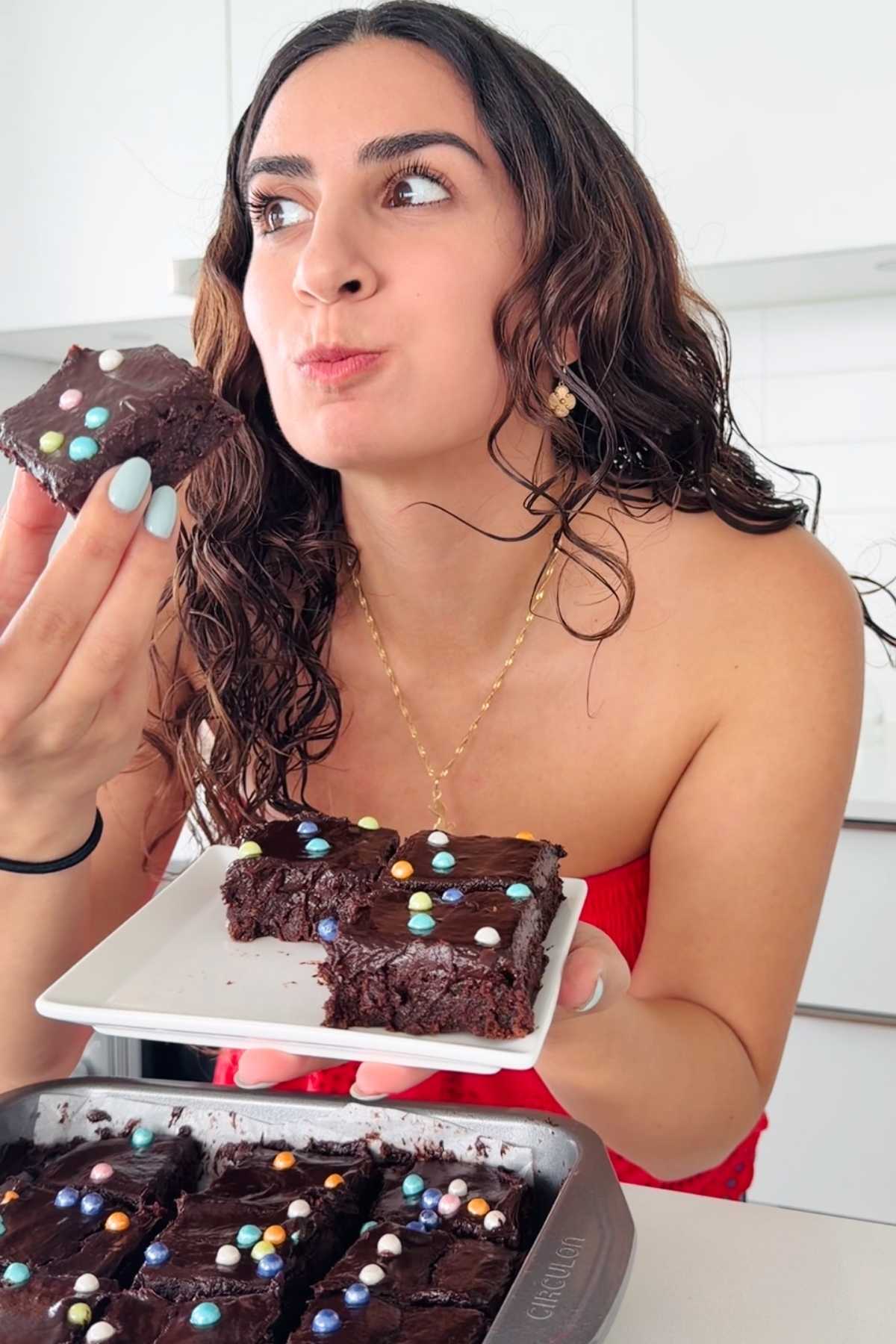 Woman eating homemade cosmic brownie.