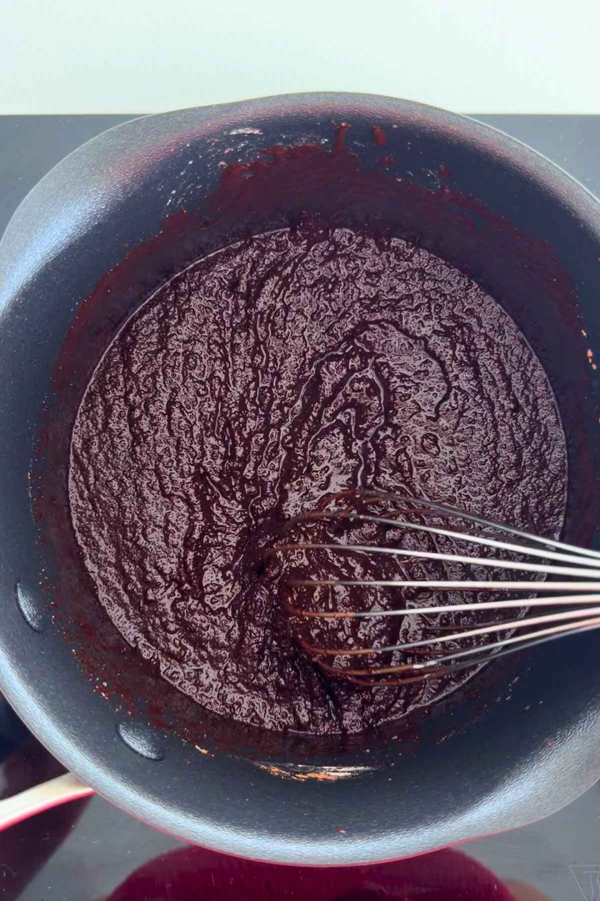 Whisking melted chocolate for homemade cosmic brownies.