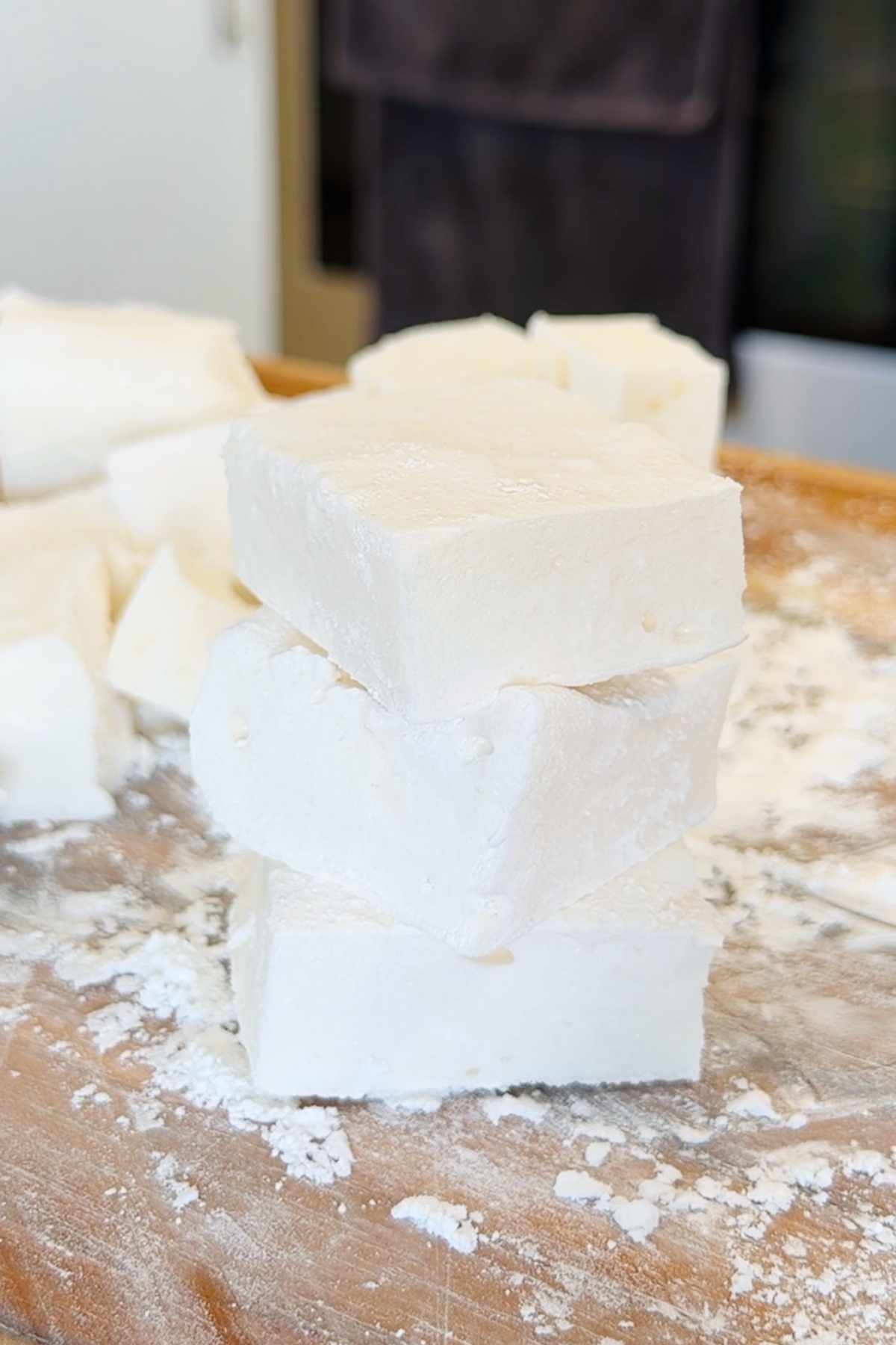 Stack of homemade marshmallows dusted with powdered sugar.
