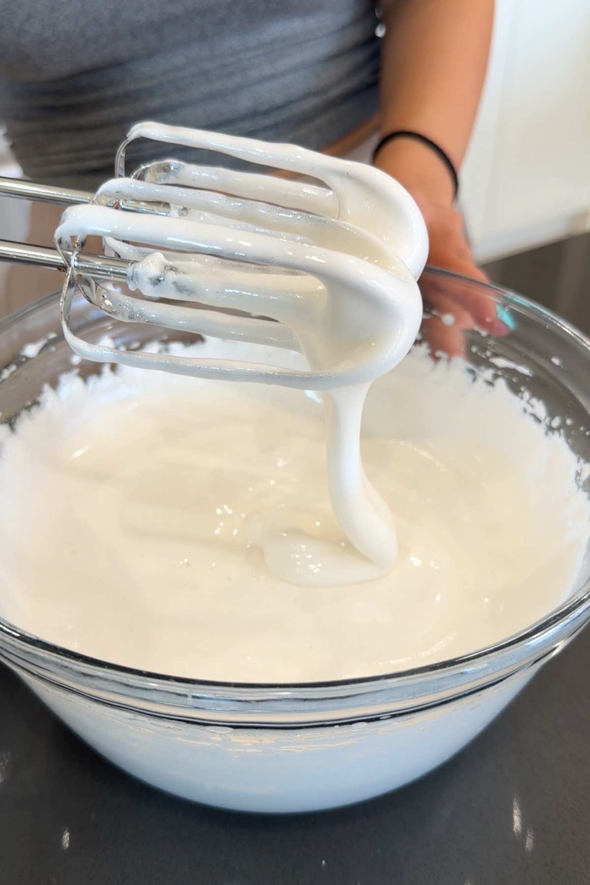 Whipped marshmallow mixture on mixer beaters.