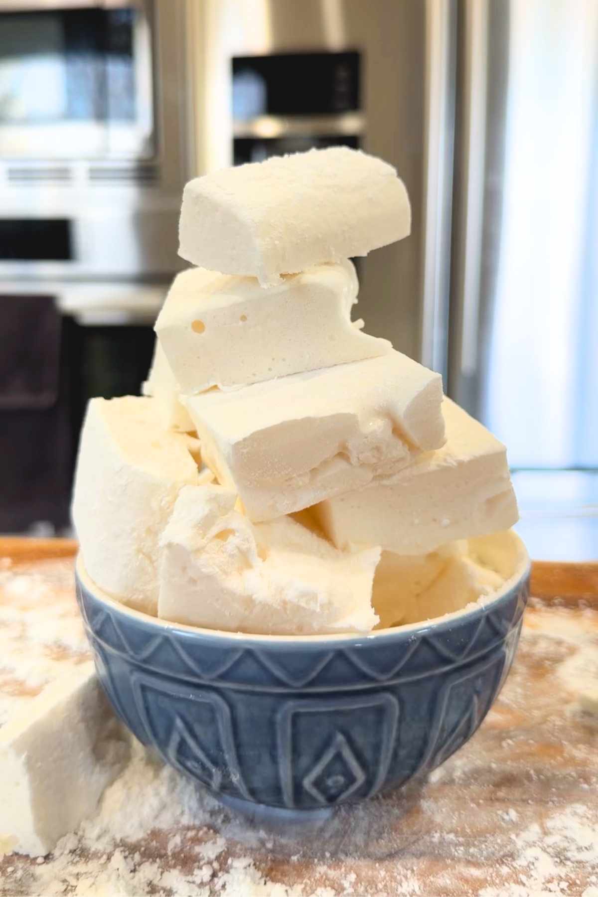 Homemade marshmallows piled in a blue bowl.