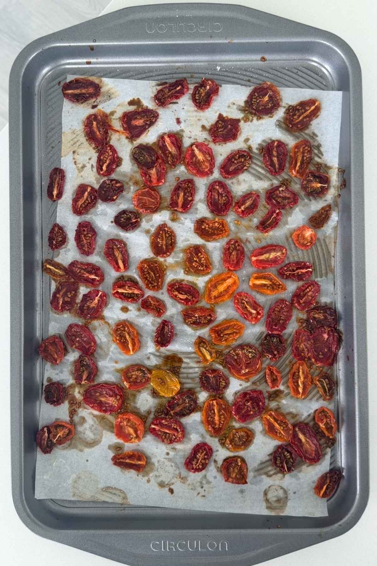 Homemade sundried tomatoes on baking sheet.